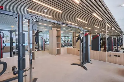 a dressing room with a gym with many equipment at Pool View Studio Near to circle mall - Icon casa Living in Dubai