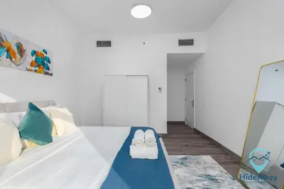 a bedroom with a bed with two towels on it at Stunning 1BR l JLTl Steps to Metro! in Dubai