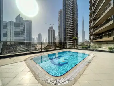 a large swimming pool on top of a building at Designer 2BR with Jacuzzi near Burj Khalifa in Dubai