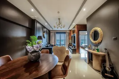 a living room with a table and a guitar at Designer 2BR with Jacuzzi near Burj Khalifa in Dubai