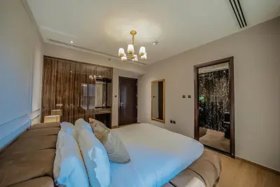 a large bed in a room with a window at Designer 2BR with Jacuzzi near Burj Khalifa in Dubai