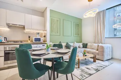 a kitchen and living room with a table and chairs at STAY BY LATINEM Luxury 1BR Holiday Home CV B 1506 near Downtown in Dubai
