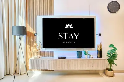 a living room with a tv on a tv stand at STAY BY LATINEM Luxury 1BR Holiday Home CV B 1506 near Downtown in Dubai