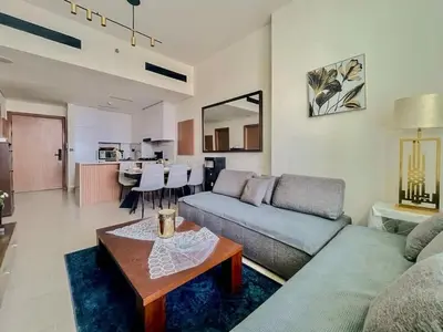 a living room with a couch and a table at Tranquil 1BR in Binghatti Amber with Free Pool & Gym! in Dubai
