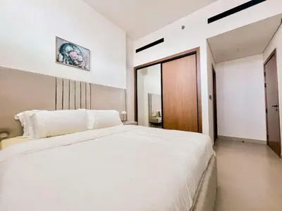 a bedroom with a large white bed in a room at Tranquil 1BR in Binghatti Amber with Free Pool & Gym! in Dubai