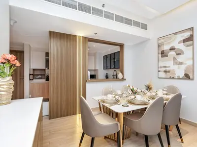 a dining room with a table and chairs at Luxurious 3BR Stunning Canal & Burj Khalifa View in Dubai