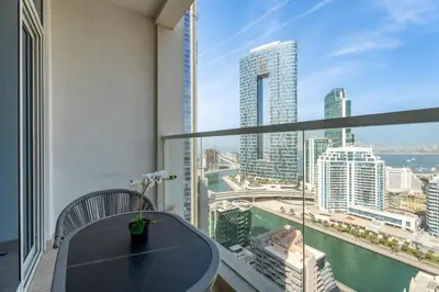 a balcony with a table and a view of the city at GuestReady | Studio | Cozy Apt with Marina View in Dubai