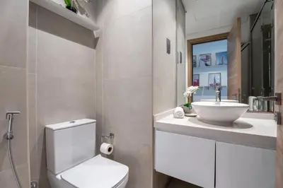 a bathroom with a white toilet and a sink at GuestReady | Studio | Cozy Apt with Marina View in Dubai