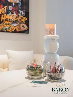 a table with two glass bowls and a large vase at The Gallery in Dubai