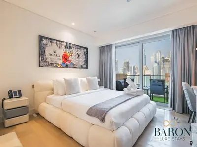a bedroom with a large bed and a large window at The Gallery in Dubai
