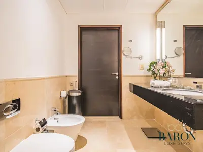a bathroom with a toilet and a sink at The Gallery in Dubai