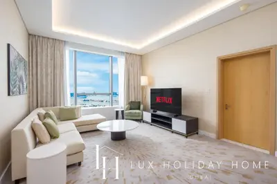 a living room with a couch and a tv at LUX Iconic Views at The Palm Tower Suite 6 in Dubai