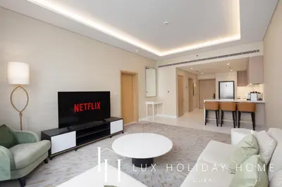 a living room with a couch and a tv at LUX Iconic Views at The Palm Tower Suite 6 in Dubai