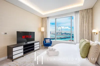 a hotel room with a bed and a tv at LUX Iconic Views at The Palm Tower Suite 6 in Dubai