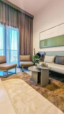a living room with a couch and a table at Stylish MAG City Stay, Near Downtown and MBR City Attractions in Dubai