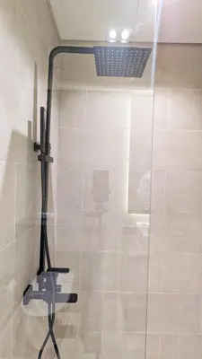 a shower with a glass door in a bathroom at Stylish MAG City Stay, Near Downtown and MBR City Attractions in Dubai