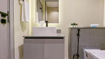 a bathroom with a counter with a laptop on it at Stylish MAG City Stay, Near Downtown and MBR City Attractions in Dubai