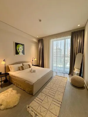 a bedroom with a large bed and a large window at Luxury Brand new 2BR nearby DIFC in Dubai