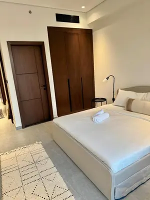 a bedroom with a large white bed with a door at Luxury Brand new 2BR nearby DIFC in Dubai