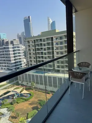 a balcony with a table and chairs on a building at Luxury Brand new 2BR nearby DIFC in Dubai
