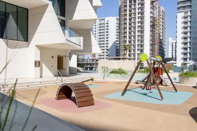 a playground in a city with tall buildings at Modern 1B with Private Jacuzzi Binghatti Phantom, JVC in Dubai