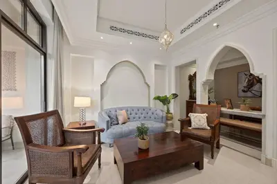 a living room with a blue couch and chairs at Authentic Arabic Lux Stay -Seconds to Burj Khalifa in Dubai