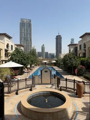 a pool with a fountain in the middle of a city at Authentic Arabic Lux Stay -Seconds to Burj Khalifa in Dubai