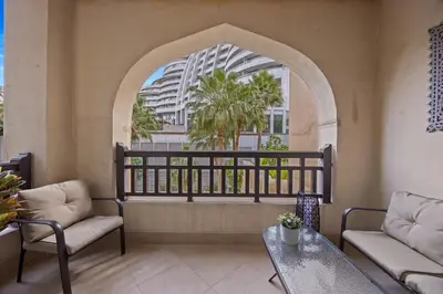 a balcony with chairs and a table and a building at Authentic Arabic Lux Stay -Seconds to Burj Khalifa in Dubai