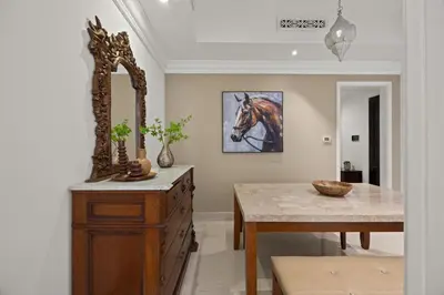 a dining room with a table and a horse painting on the wall at Authentic Arabic Lux Stay -Seconds to Burj Khalifa in Dubai