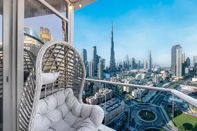a balcony with a chair and a view of a city at Full Burj Khalifa Fountain View Near Dubai Mall Downtown in Dubai