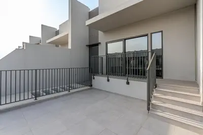 a balcony of a building with stairs and windows at MAG City Private Villa, 3BR with Pool, Garden & BBQ in Dubai