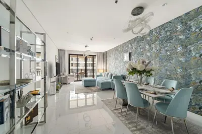 a dining room with a table and blue chairs at FIRST CLASS 1BR Serene Sea View Royal Amwaj in Dubai