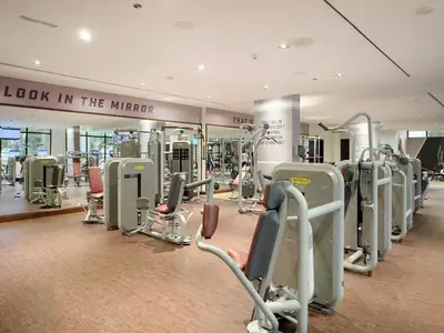 a gym with many treadmills and machines in it at FIRST CLASS 1BR Serene Sea View Royal Amwaj in Dubai