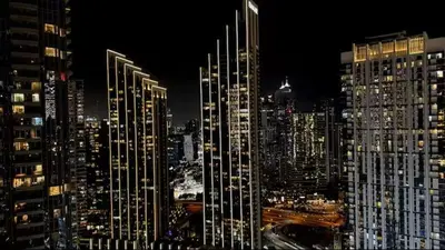 a view of a city at night with tall buildings at Luxury 1Bedroom Burj Khalifa View from Infinity Pool Grande Signature Residences in Dubai
