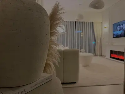 a rendering of a living room with a couch and a fireplace at Luxury 1Bedroom Burj Khalifa View from Infinity Pool Grande Signature Residences in Dubai