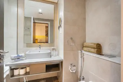 a bathroom with a sink and a mirror at Sleek Home in Business Bay with Panoramic Views in Dubai