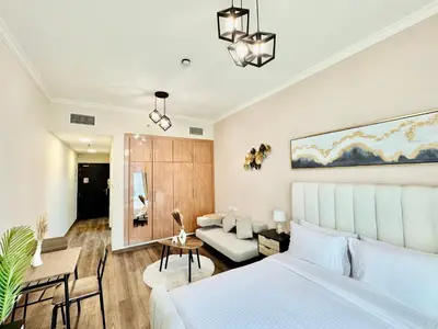 a bedroom with a bed and a living room at Cosmos Living Work-Friendly with Easy Metro Access in Dubai