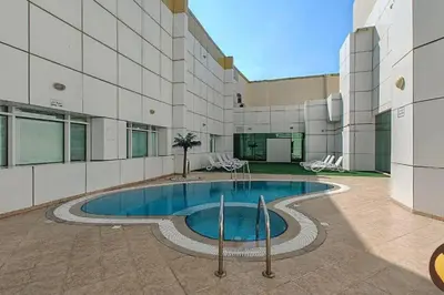 a swimming pool in the middle of a building at Cosmos Living Work-Friendly with Easy Metro Access in Dubai