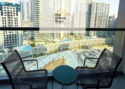 a balcony with a table and chairs and a view of a city at Livo in Dubai