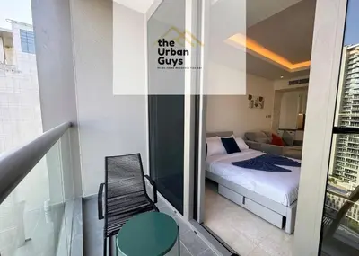 a small bedroom with a bed and a balcony at Livo in Dubai