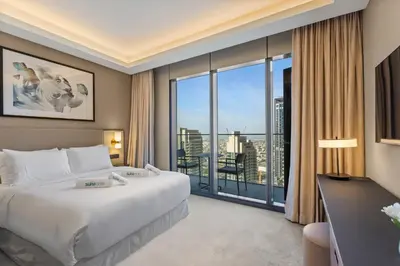 a hotel room with a bed and a large window at High-End 2Bedroom Near Dubai Opera & Mall in Dubai