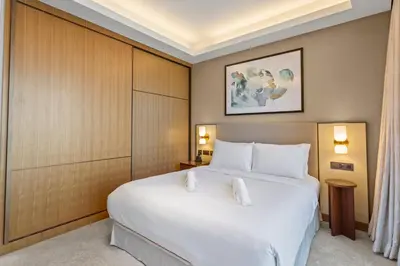 a bedroom with a large white bed in a room at High-End 2Bedroom Near Dubai Opera & Mall in Dubai