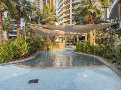 a swimming pool with a hammock in a building at VayK - Luxurious 3BR in Business Bay with Burj Khalifa View in Dubai