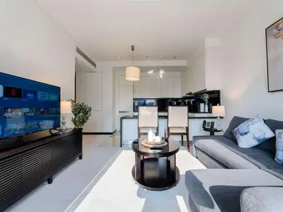 a living room with a couch and a table at Incredible Views at The Address Dubai Marina 1BR in Dubai