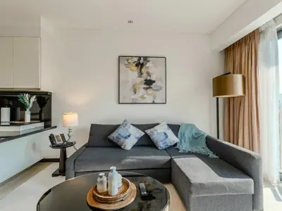 a living room with a couch and a table at Incredible Views at The Address Dubai Marina 1BR in Dubai
