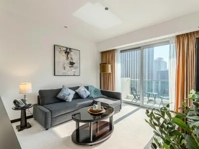 a living room with a couch and a large window at Incredible Views at The Address Dubai Marina 1BR in Dubai