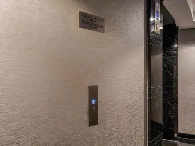 a bathroom door with a sign on the wall at Cayan Tower, The Twist - Marina Views & Free Pool in Dubai