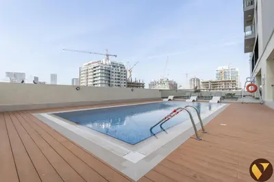 a swimming pool on the roof of a building at Vogue JVC Jeewar Tower Near Circle Mall, One Bedroom Apartment with Balcony and City View, Access to all Amenities in Dubai