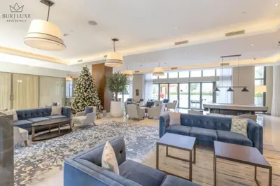 a lobby with blue couches and a christmas tree at Address Residences Dubai Opera 3-bed Full Burj & Fountain View, Downtown Dubai in Dubai