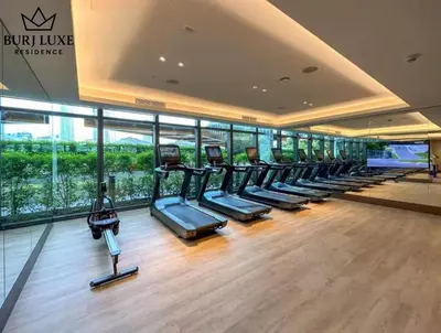 a gym with a row of treadmills in a building at Address Residences Dubai Opera 3-bed Full Burj & Fountain View, Downtown Dubai in Dubai